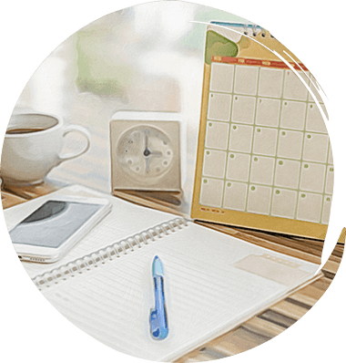 Desk with a calendar, notebook, and smartphone